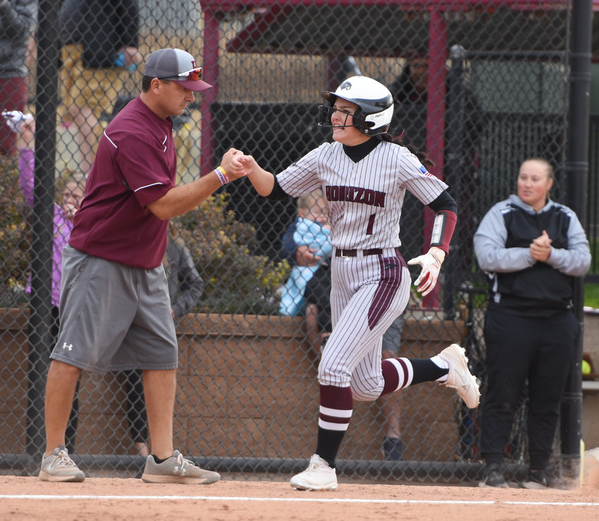 Horizon's Madison Shama gets the congratulations from coach Gary Mares after hitting a home run against Legend in a CHSAA 5A state semifinal Oct. 230 at Aurora Sports Park. The top-seeded Hawks' title hopes were dashed by the Titans 7-2.